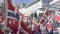 Large Norwegian flags waving over norwegian heads