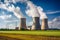 Large nuclear power plant with cooling towers emitting steam, producing energy in a rural landscape