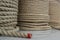 A large number of the twisted ropes in a roll. Ropes on a counter of shop. Sale of various ropes