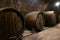 Large oak wine barrels stand in an old ancient cellar