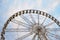 Large observation wheel on sky background