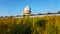 A large observatory is protected by a barbed fence