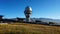 A large observatory is protected by a barbed fence