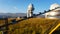 A large observatory is protected by a barbed fence