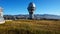 A large observatory is protected by a barbed fence