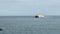 Large ocean ferry catamaran of yellow-white color moves on the water surface of the ocean