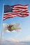 Large official Flag of US with smaller flag of Illinois state, Usa at cloudy sky background. United states of America patriotic