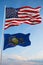 Large official Flag of US with smaller flag of Pennsylvania state, Usa at cloudy sky background. United states of America