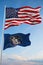 Large official Flag of US with smaller flag of Utah state, Usa at cloudy sky background. United states of America patriotic