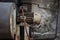 A large, old, rusty, powerful ventilation motor in an abandoned metal processing plant.