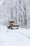 Large old snow truck driving towards camera on a winter environment