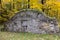 Large old stone root cellar with sturdy wooden door on Chemin Royal in the Fall