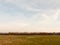 large open farm field empty grass grassland spring sky