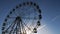 Large operating metal Ferris wheel ride turns in local park