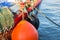 Large orange buoy on red fishing boat.