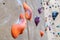 Large orange climbing holds with traces of chalk powder.