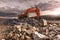 Large orange excavator in the construction works of the Madrid-Segovia-Valladolid highway Spain