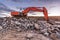 Large orange excavator in the construction works of the Madrid-Segovia-Valladolid highway Spain