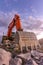 Large orange excavator in the construction works of the Madrid-Segovia-Valladolid highway Spain