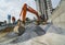 Large orange excavator working on a gravel on construction site. Details of industrial excavator. Big excavator standing