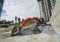 Large orange excavator working on a gravel on construction site. Details of industrial excavator. Big excavator standing