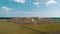 Large orange garbage truck moves through a huge landfill view from the drone.