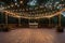 large outdoor dance floor surrounded by twinkle lights and lanterns