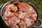 In a large pan there are many pieces of meat with marinade, for grilling roasting, close-up