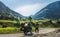 Large panorama in the center girl in full body protection, turtle armor, knee pads and helmet, motorcycle for traveling with large