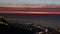 Large panoramic view  of lebanese shore of Kaslik and Jounieh and beirut in a far end by night with the red light of dusk