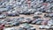 Large parking lot near the shopping center, a lot of cars and hurrying people