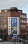 Large parking sign on a building on the corner of Lady Lane in Leeds with traffic and road signs