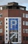 Large parking sign on a building on the corner of Lady Lane in Leeds with traffic and road signs