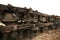 Large parts of a disassembled train, huge train wheels, a rusty metal structure stands on rails