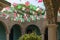Large patio on a terrace outside a Mexican hacienda with flags and decorations typical of Mexico