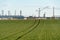 A large petrochemical enterprise on the background of a wheat field. Next to the agricultural field there\\\'s a factory