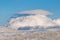 A large picturesque cloud over the frozen winter highlands