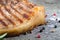 Large piece of fresh pork meat on a bone prepared on a grill pan on old wooden table for background