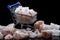 Large pieces of pink himalayan salt lying on a black glossy background and stacked in a small shopping cart on a black background