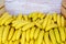 A large pile of appetizing looking yellow bananas in a container box, copy space