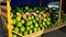 A large pile of green striped watermelons, a market bench for a watermelon merchant, cut red watermelons lie on top