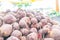 Large pile of red beet root vegetables, dried and cured, harvested and being sold at a farmer`s market. Soft, hazy lighting