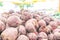 Large pile of red beet root vegetables, dried and cured, harvested and being sold at a farmer`s market. Soft, hazy lighting