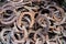 Large pile of rusty used Horseshoes