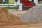 A large pile of sand laying on the outdoor area in the construction zone, building an industrial house building idea.