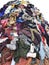 Large pile stack of textile fabric clothes and shoes. concept of recycling, up cycling, awareness to global climate change