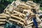 A large pile of wooden  cardboard and plastic crates on a garbag