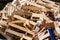 A large pile of wooden  cardboard and plastic crates on a garbag