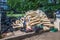 A large pile of wooden  cardboard and plastic crates on a garbage heap. Wooden and plastic and cardboard boxes from under berries