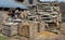 Large piles of firewood near the rustic barn